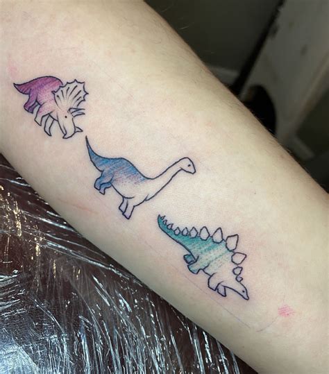 Matching alien tattoos can work in two ways. . Dino matching tattoos